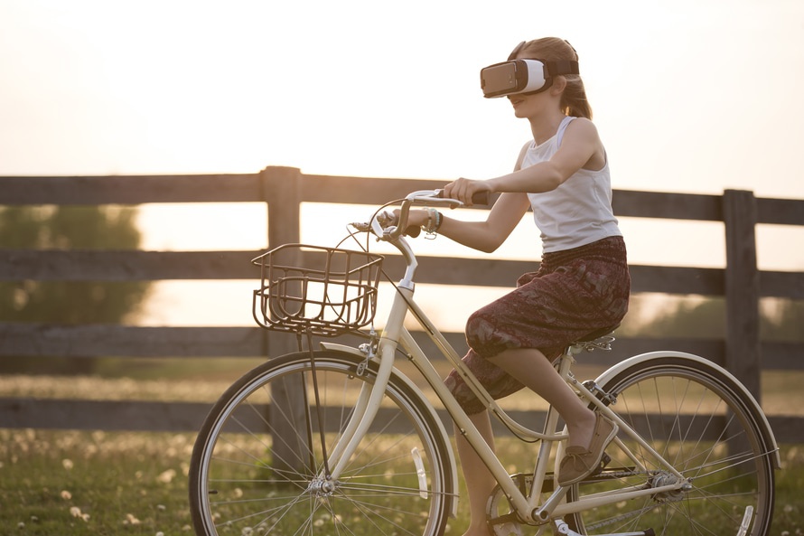A bike rider using a headset to interact with entertainment and virtual reality. Photo by: Sebastian Voortman