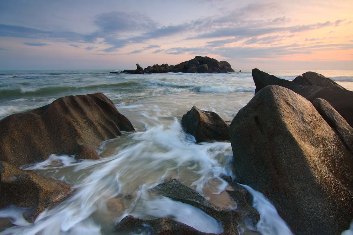 The tide hitting a set of rocks. Photo by: Pexels.com