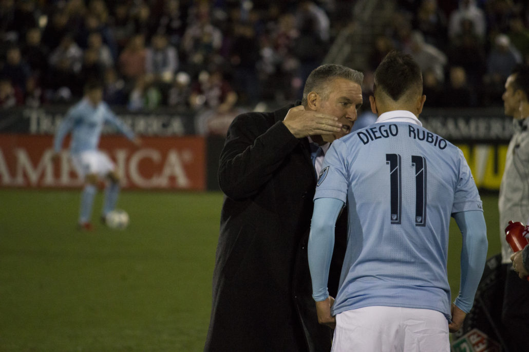 Coach Peter Vermes talks with Diego Rubio. Photo by: Matthew McGuire on 03/24/18 at Dick's Sporting Goods Park