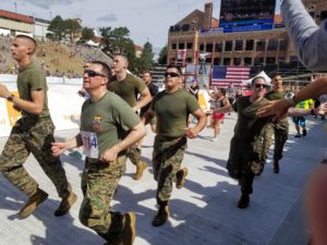 Military members enter Folsom Field during BolderBOULDER 2018. Photo by: Matthew McGuire