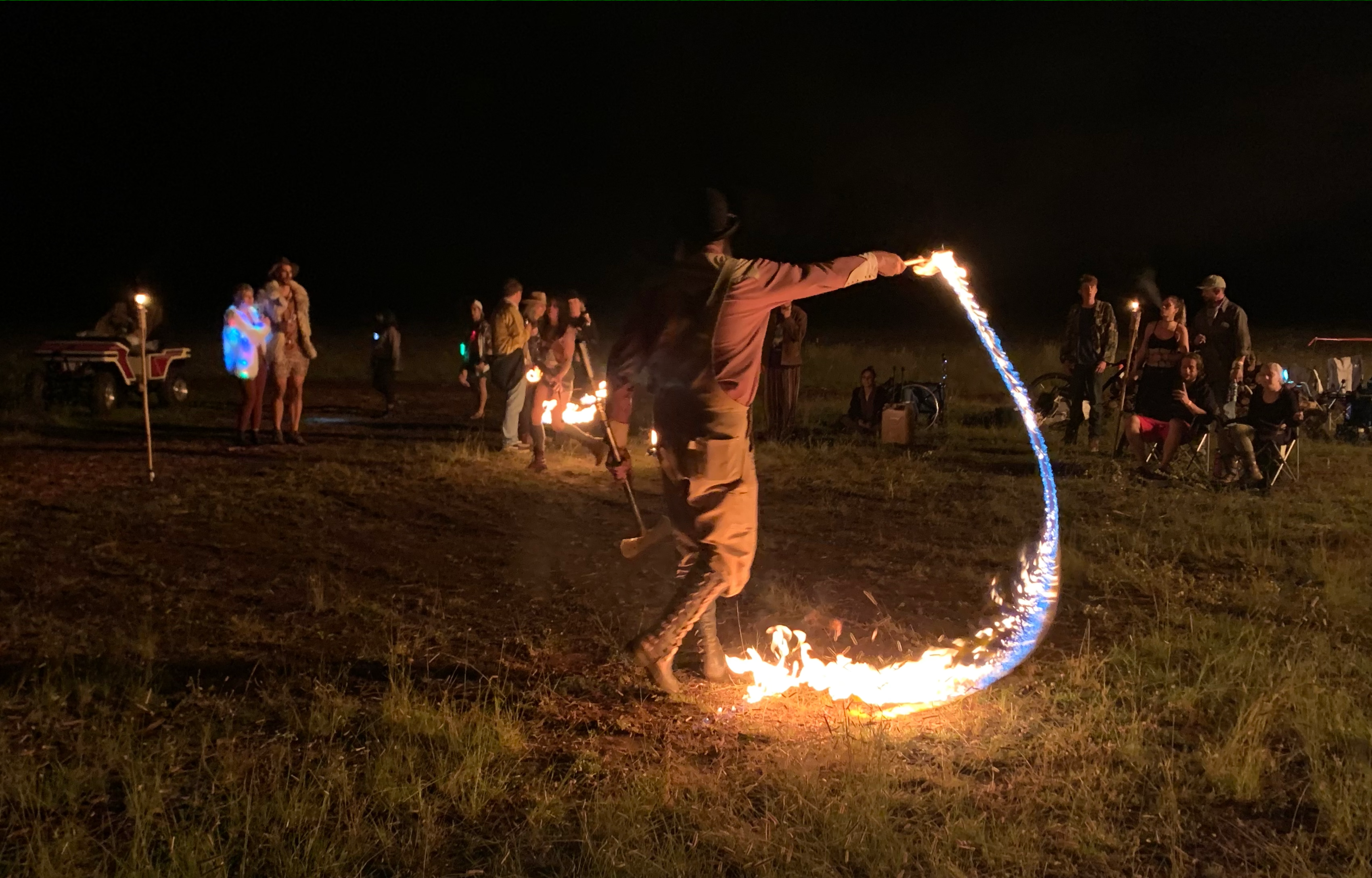 Fire spinners begin their performance with a fire whip and fire fans Friday evening. Photo by: Matthew McGuire