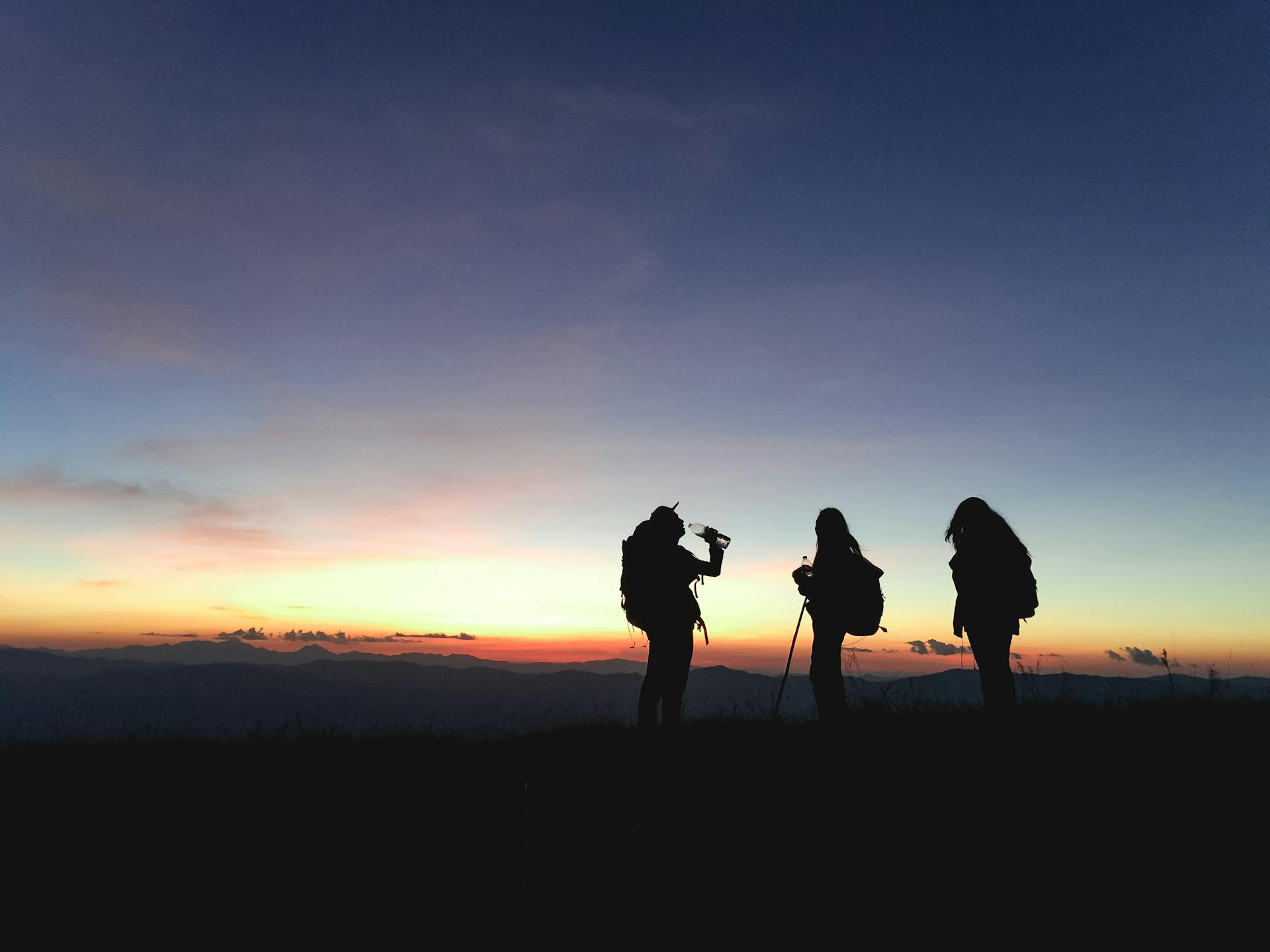 A group of people hiking on a mountain top. Photo by: Pexels.com | Tirachard Kumtanom